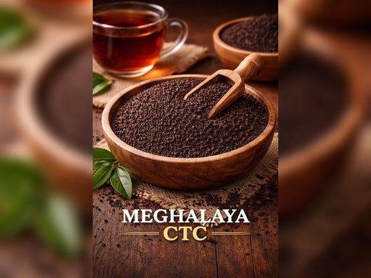 Wooden bowl with Meghalaya CTC tea, a cup of tea, and leaves on a wooden surface.