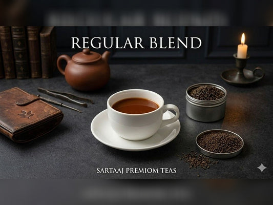 Regular blended Assam and Darjeeling Brokens Tea setup with a cup, teapot, and tea leaves on a dark surface, featuring 'Sartaaj Premium Teas'.